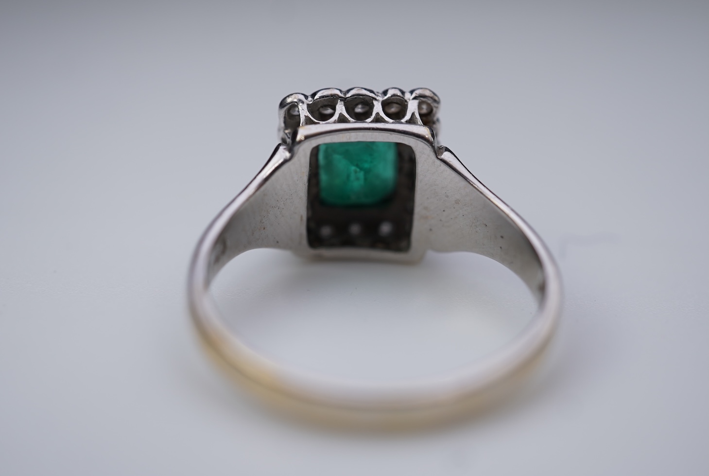 An emerald and diamond ring